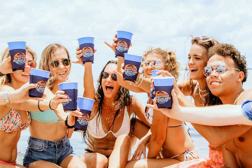 Friends raising glasses on a Tampa Bay party boat trip.