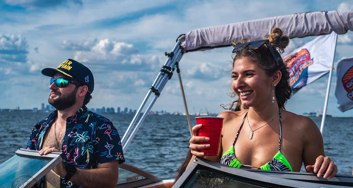 Party boat captain and beautiful girl on a boat in Tampa Bay, FL.