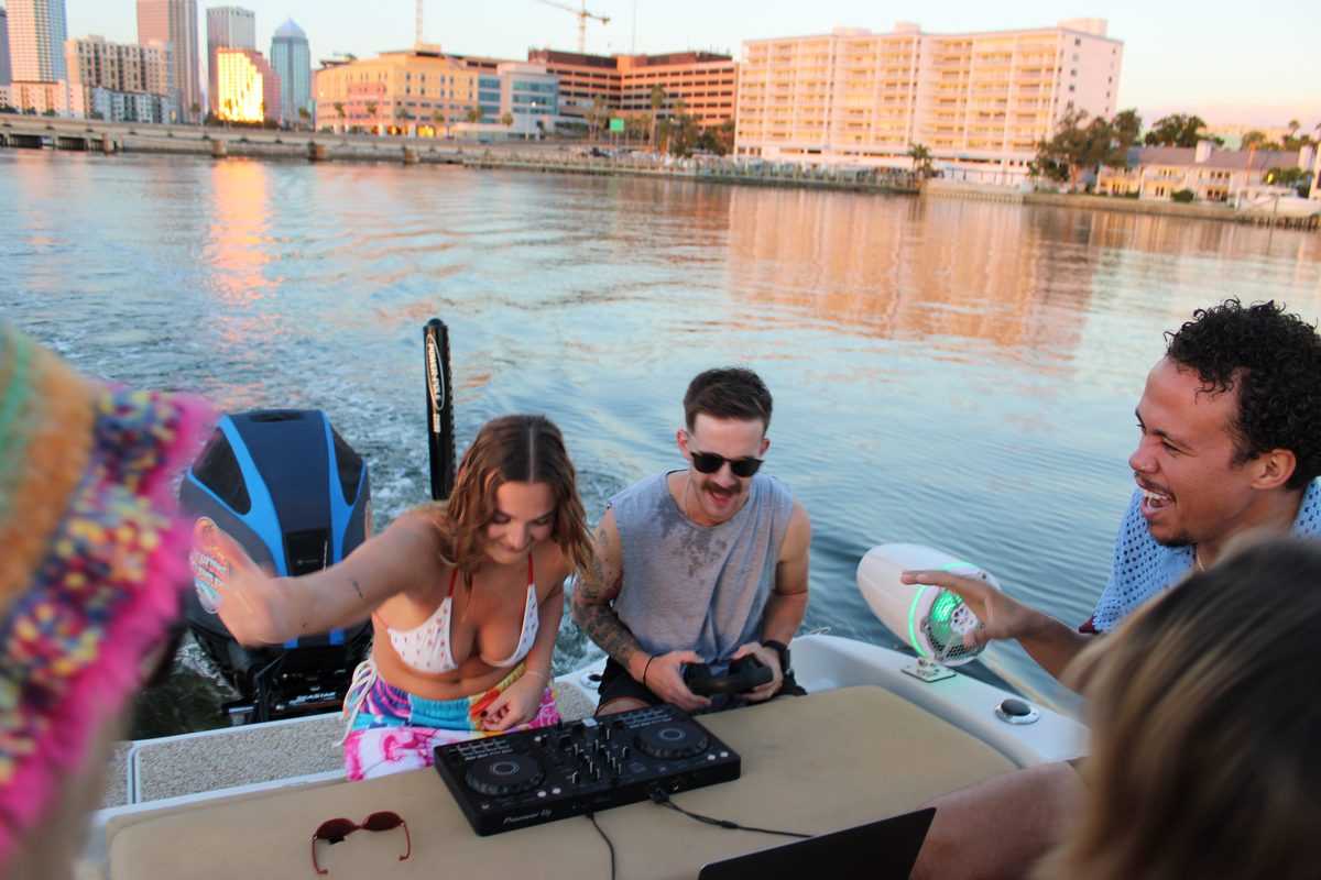 DJ set on deck with the Tampa skyline across the water.