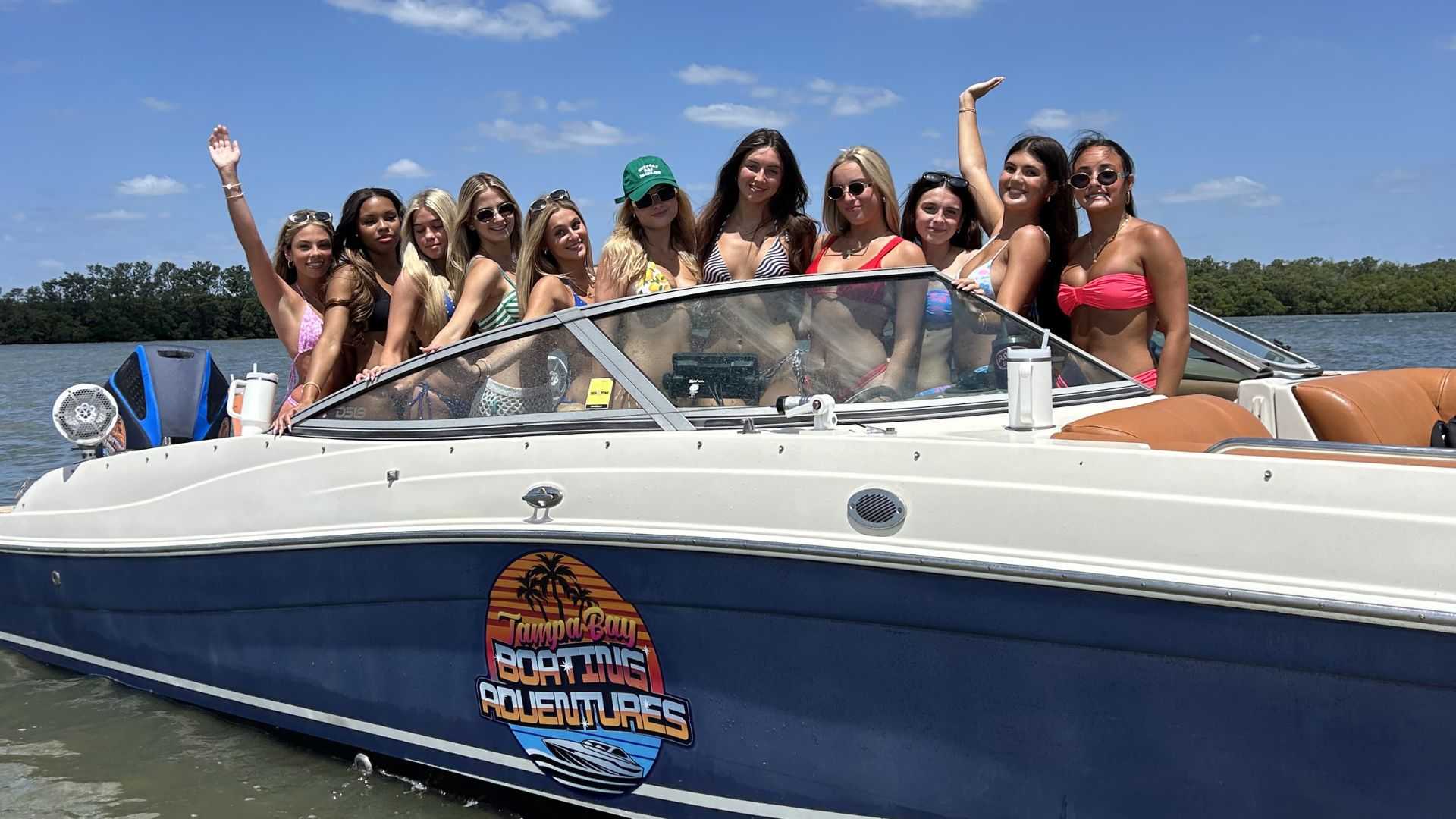 Group boarding a private charter boat at a Tampa Bay dock.