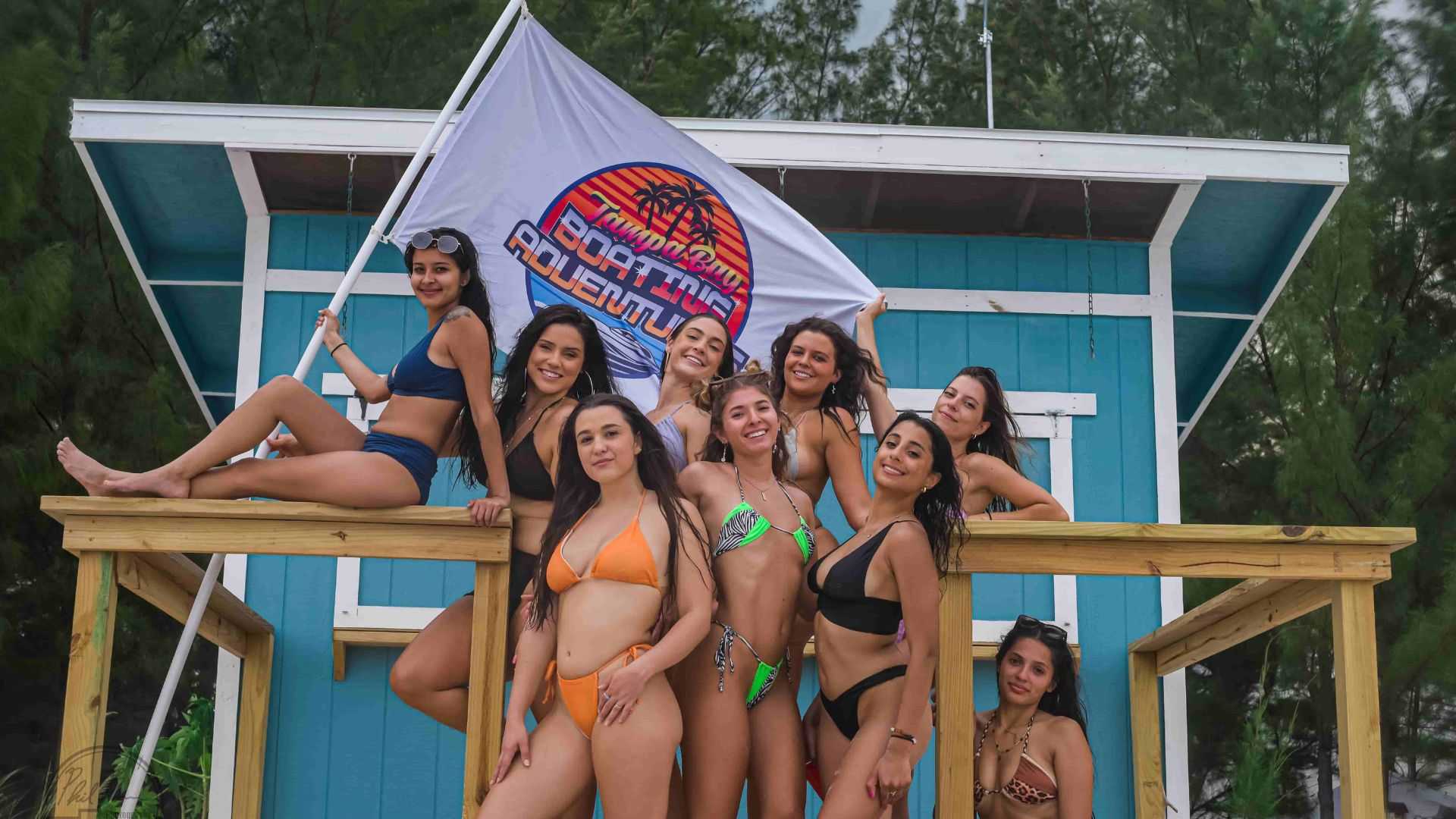 Bachelorette party group posing together on a private boat day in Tampa Bay, FL.