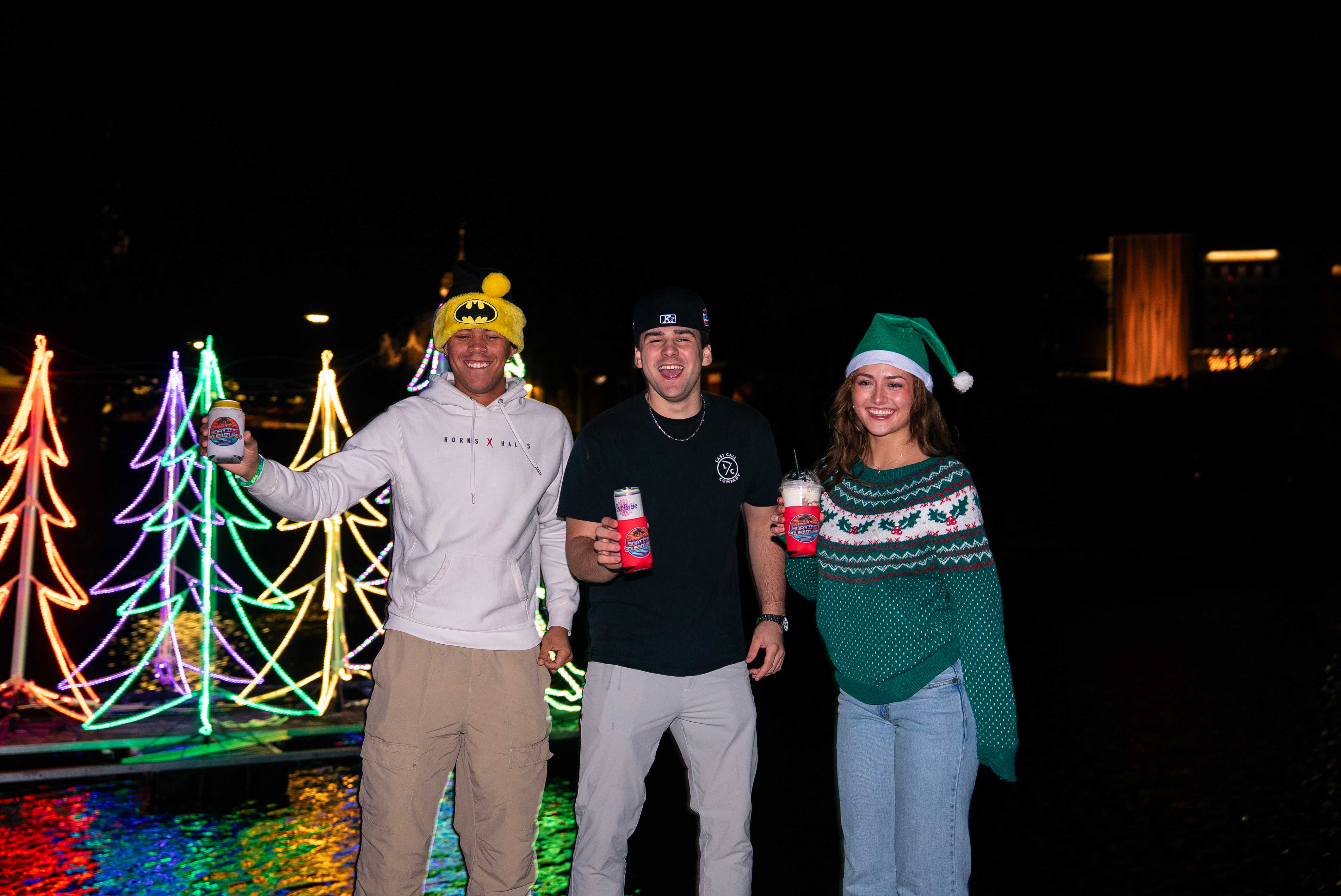 Holiday lights tour boat passing decorated waterfront homes in Tampa Bay.
