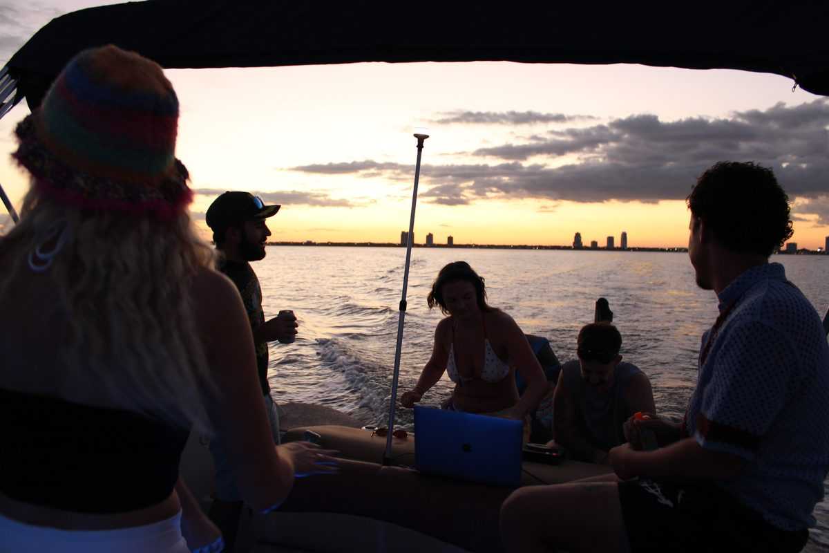 Group silhouetted at sunset on Tampa Bay.