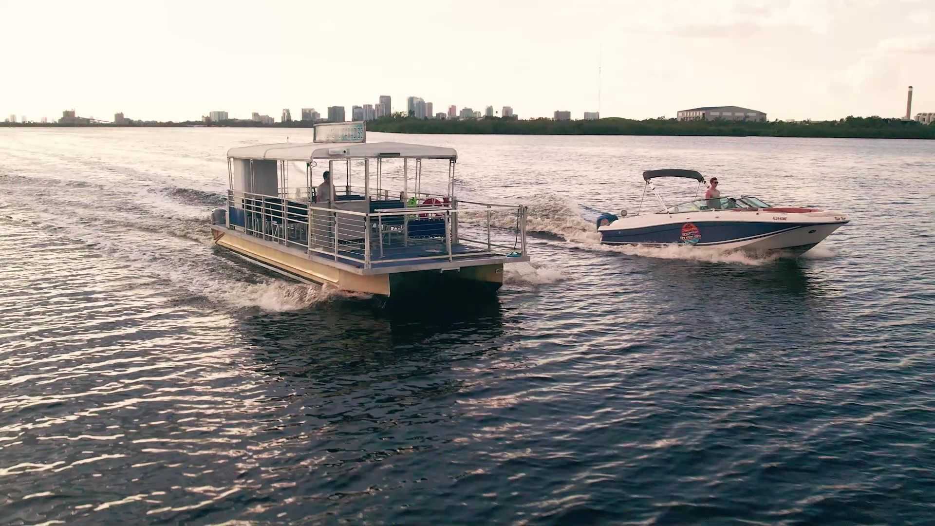 Boats cruising on Tampa Bay with storm clouds in the distance during hurricane season.