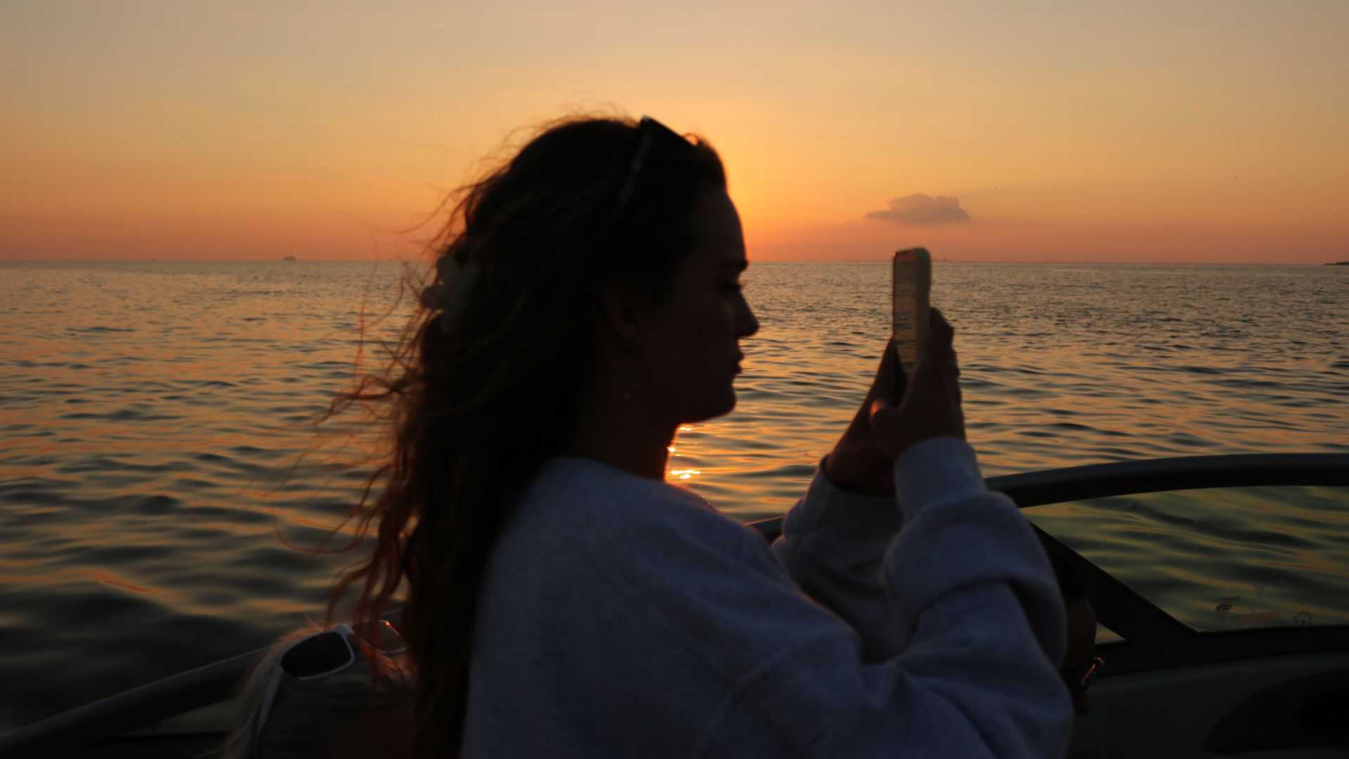 TBBA intern taking group photos on a Tampa Bay charter.
