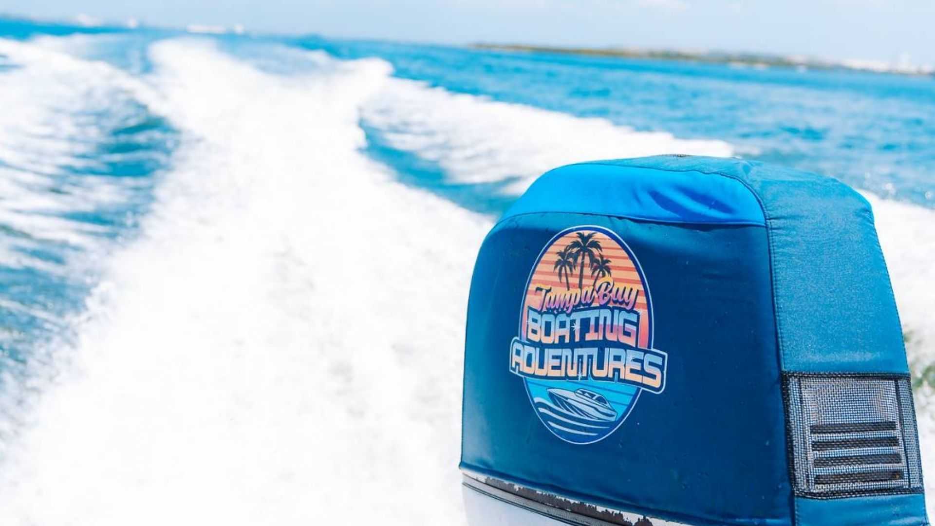 Two friends laughing with drinks in hand on a sunny Tampa Bay boat day.