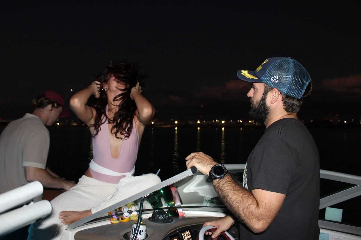 Captain at the helm on a night cruise past Tampa.