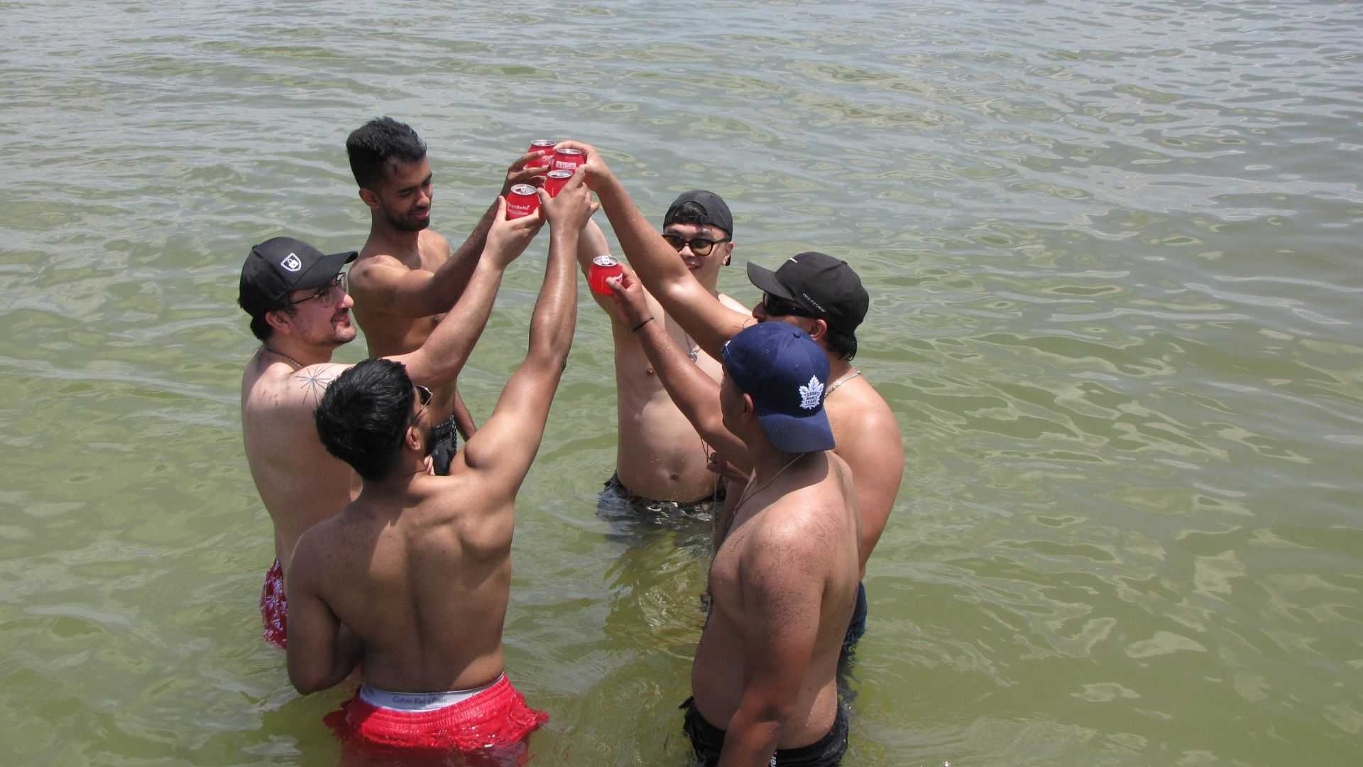 Friends swimming and floating near a local island in Tampa Bay.
