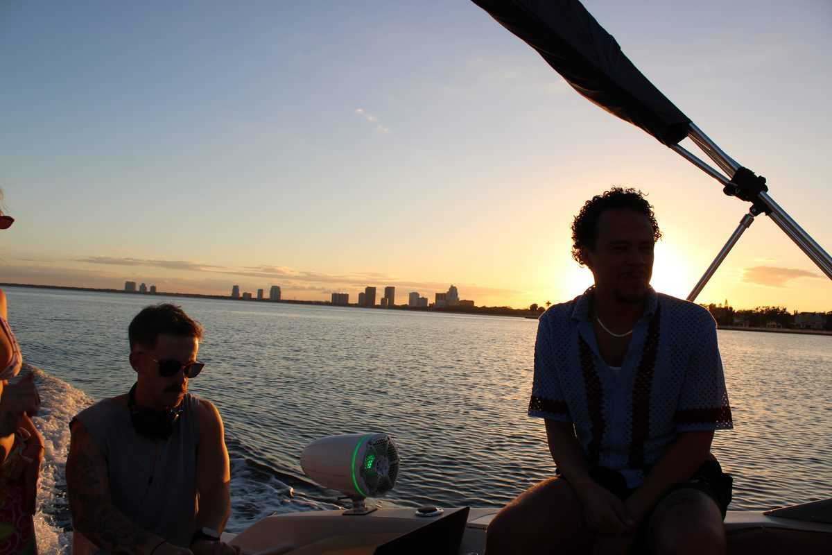 Silhouettes at sunset on Tampa Bay beside the DJ booth.