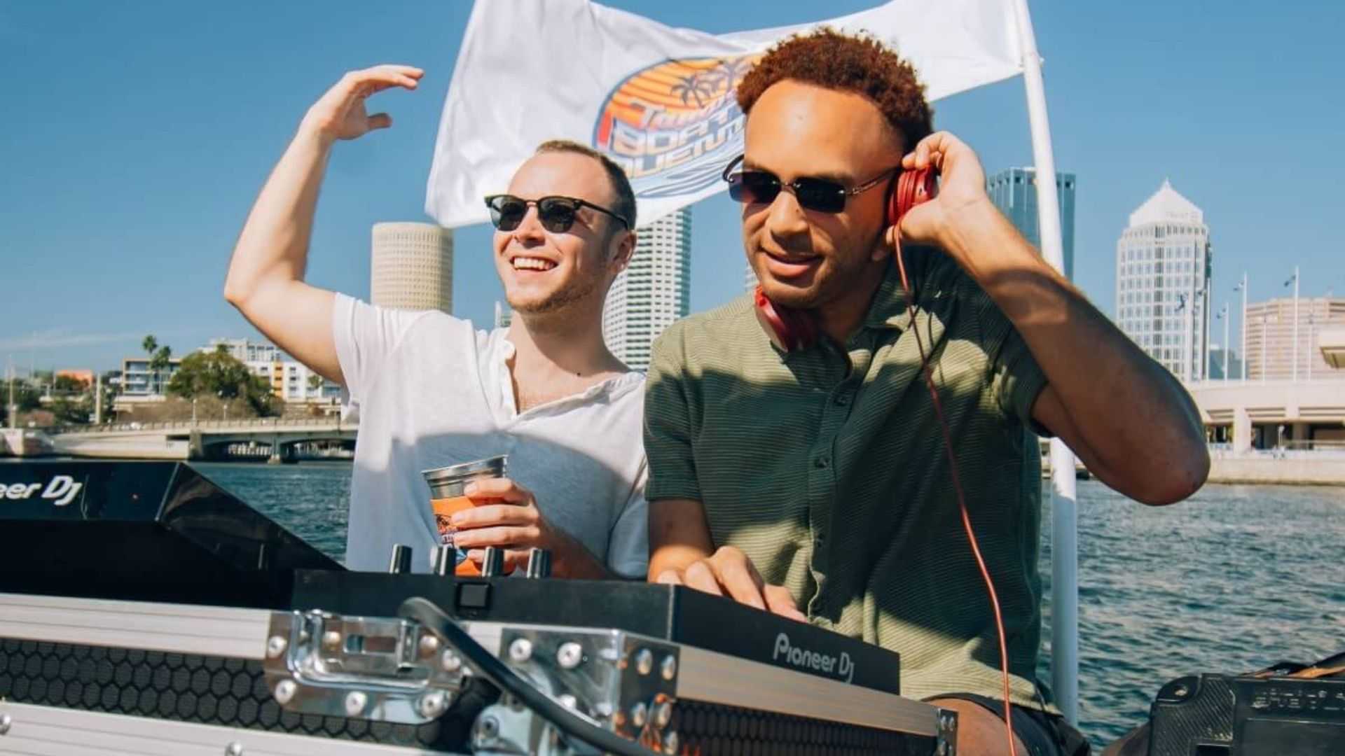 Friends partying with a DJ on a private bachelor party boat in Tampa Bay, FL.