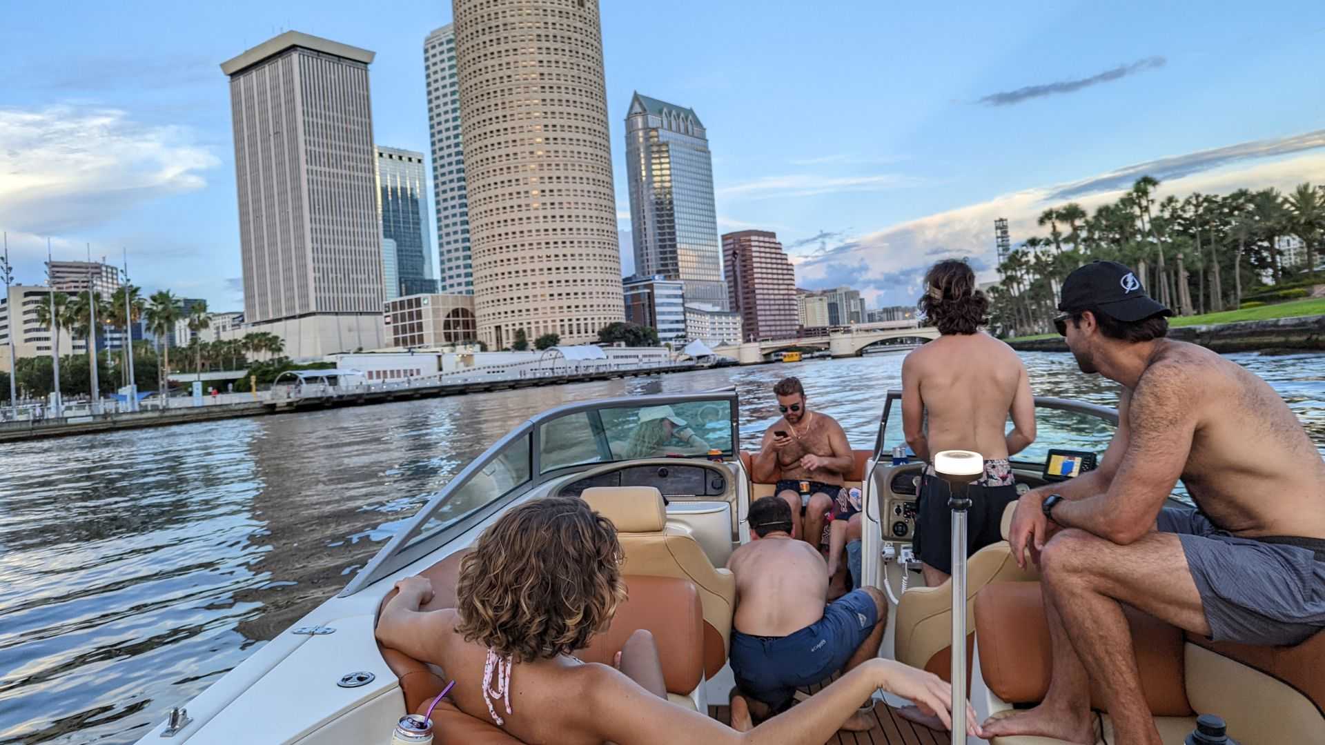 Group of friends enjoying a Tampa Bay boat day with downtown skyline views.