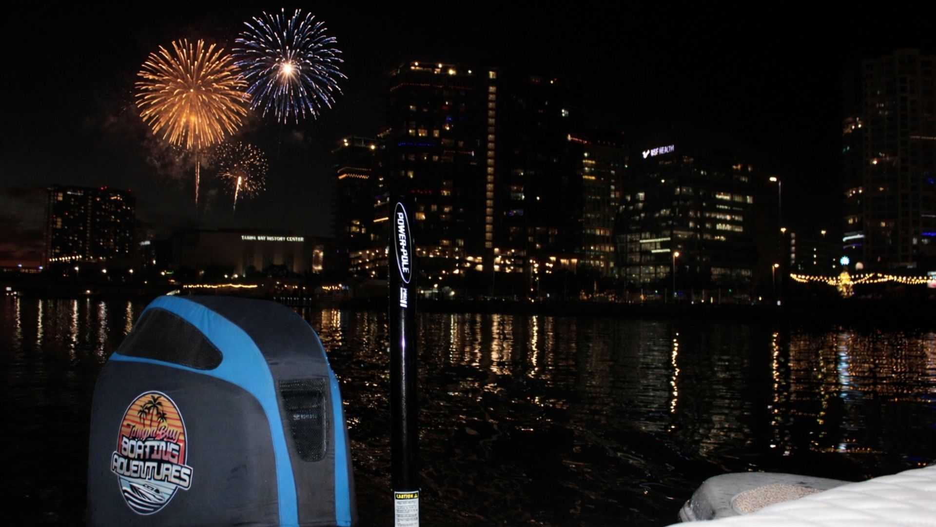 Fireworks over downtown Tampa viewed from a charter boat at night.