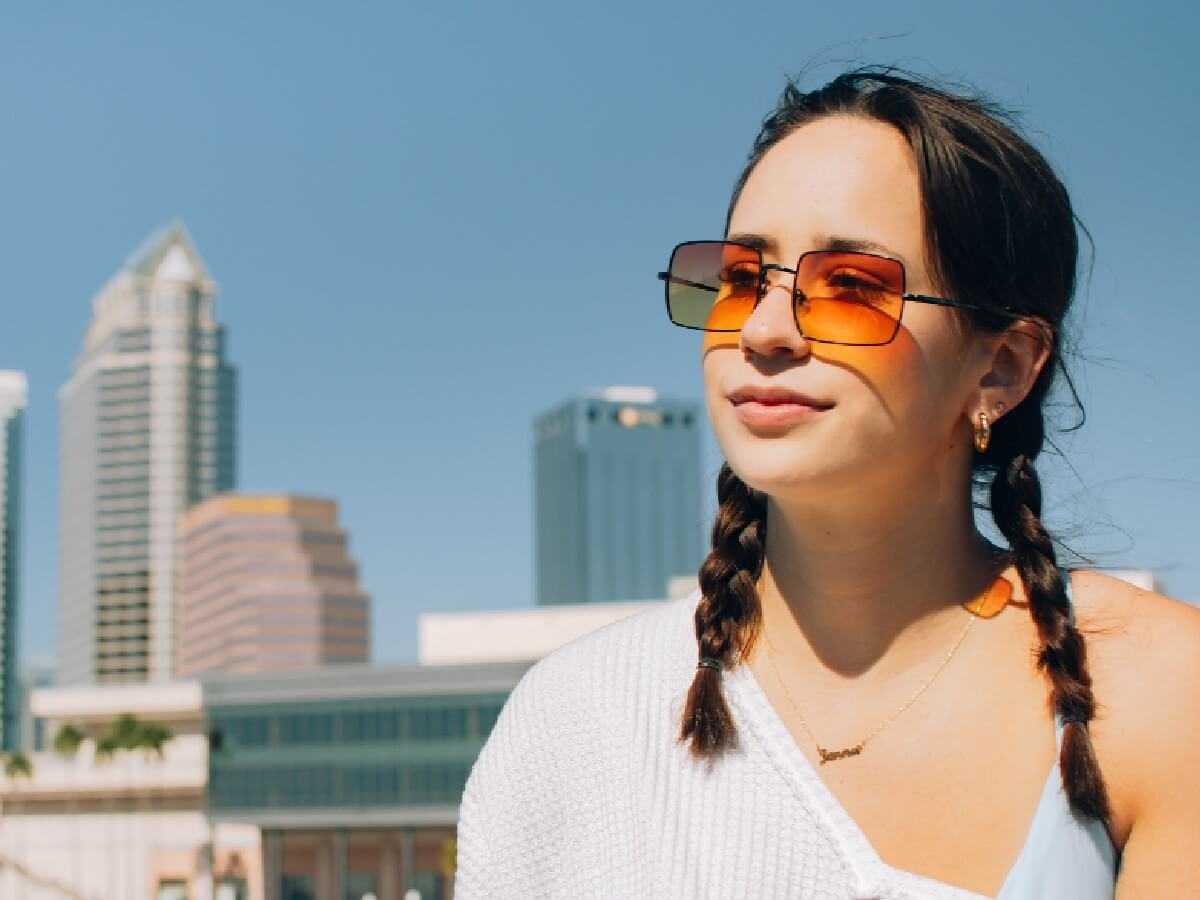 Guest smiling on deck with the Tampa skyline behind her.