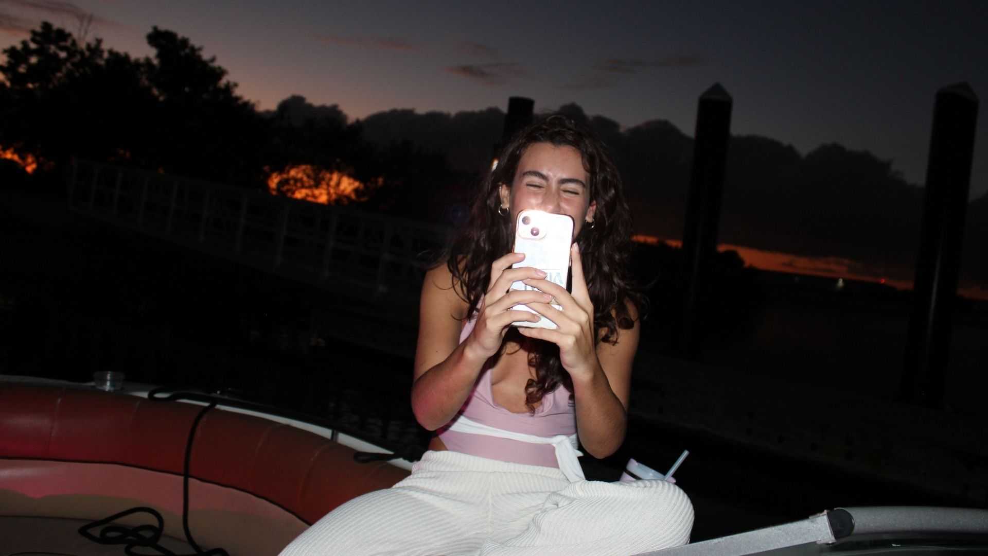 Intern helping guests take fun photos on a Tampa Bay boat day.