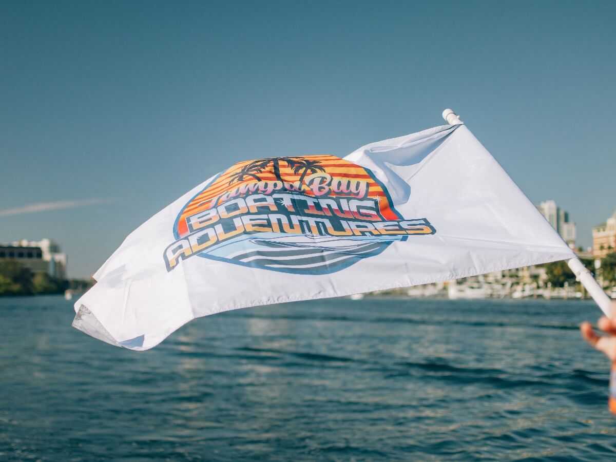 Tampa Bay Boating Adventures flag flying with the downtown skyline behind.