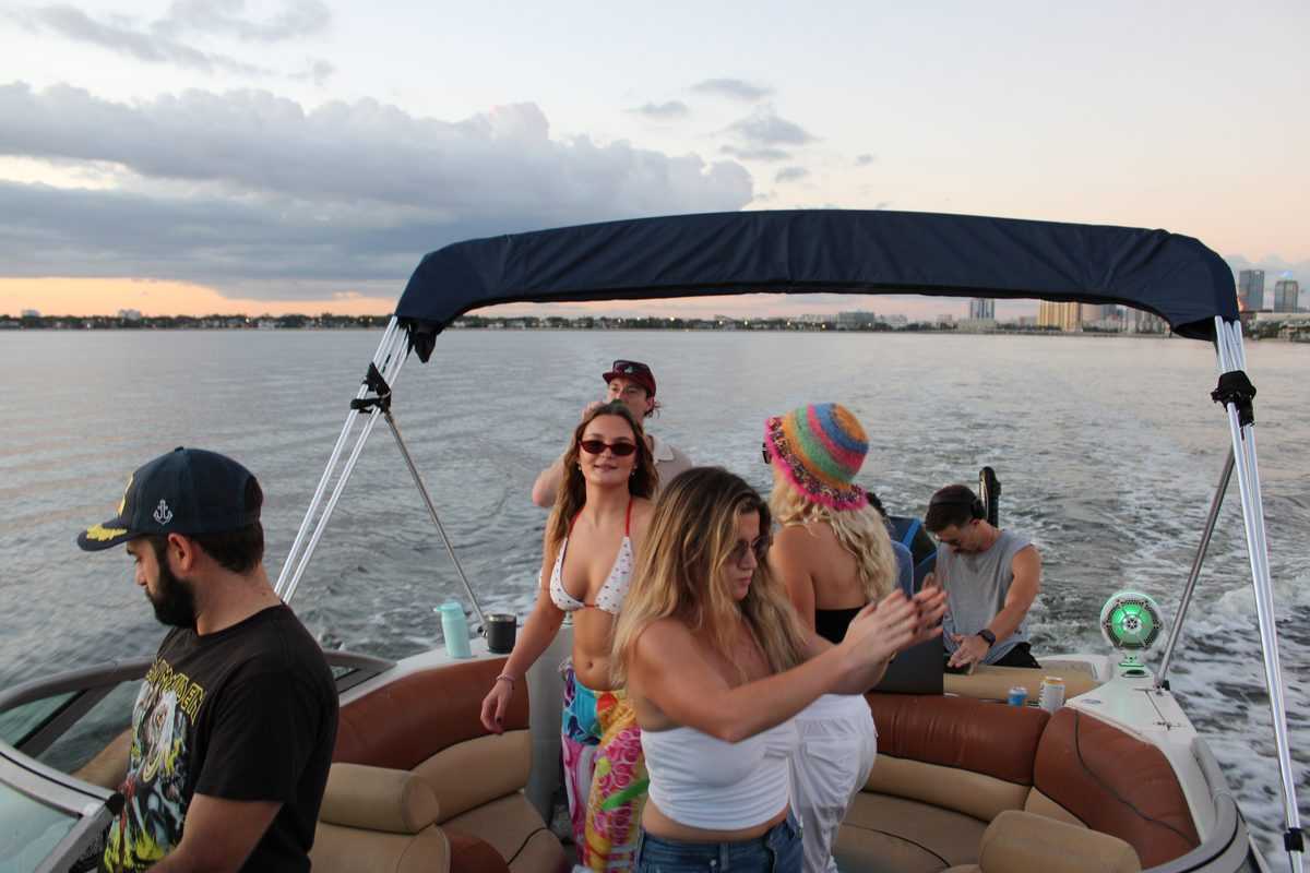 Group dancing on deck at dusk on Tampa Bay.