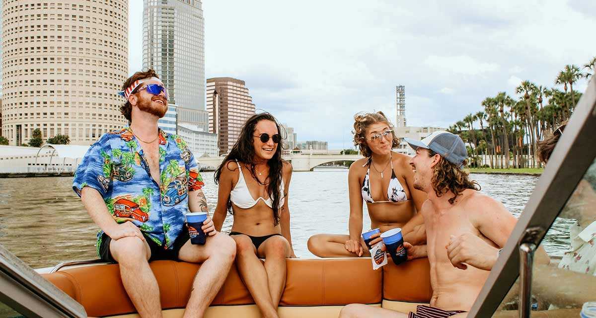 Friends talking on a party boat in Tampa Bay, FL.