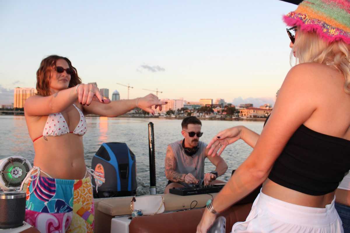 Dancing under the bimini with the Tampa skyline behind.
