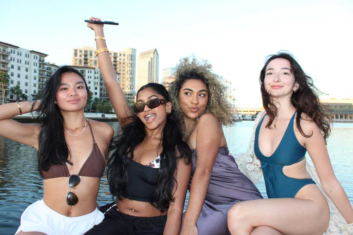 Friends cheering from the bow along the downtown Tampa waterfront.