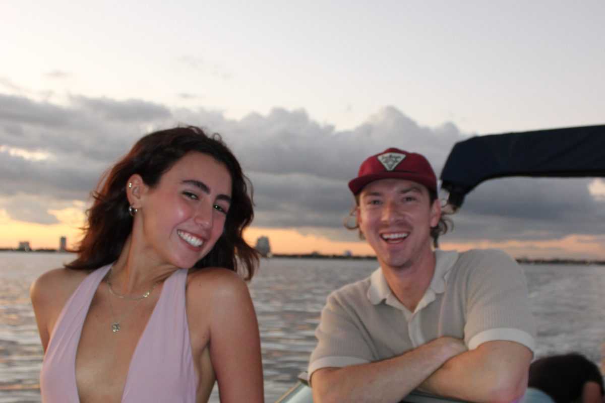 Couple at the helm at sunset in Tampa.