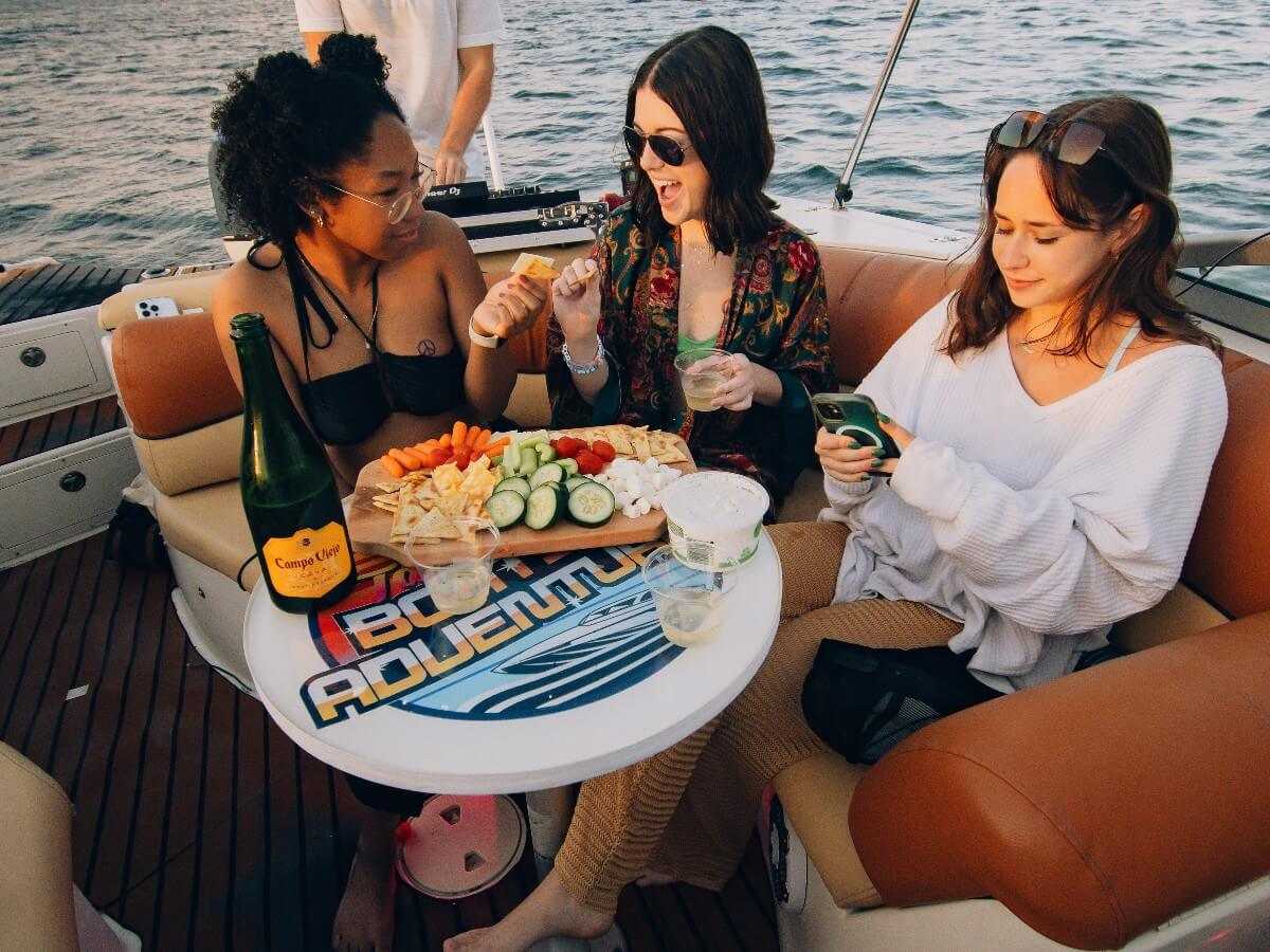 Guests sharing a charcuterie board around the table on board.