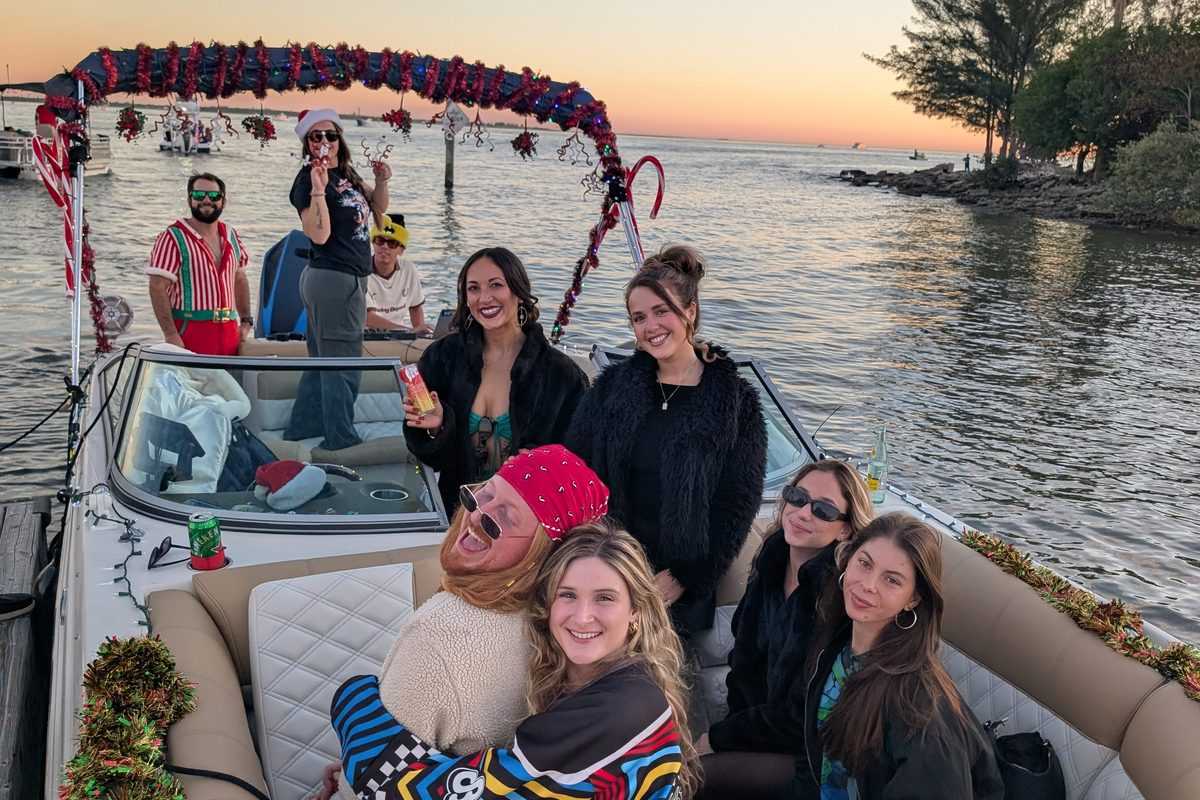 Group in the decorated boat at sunset before the parade.