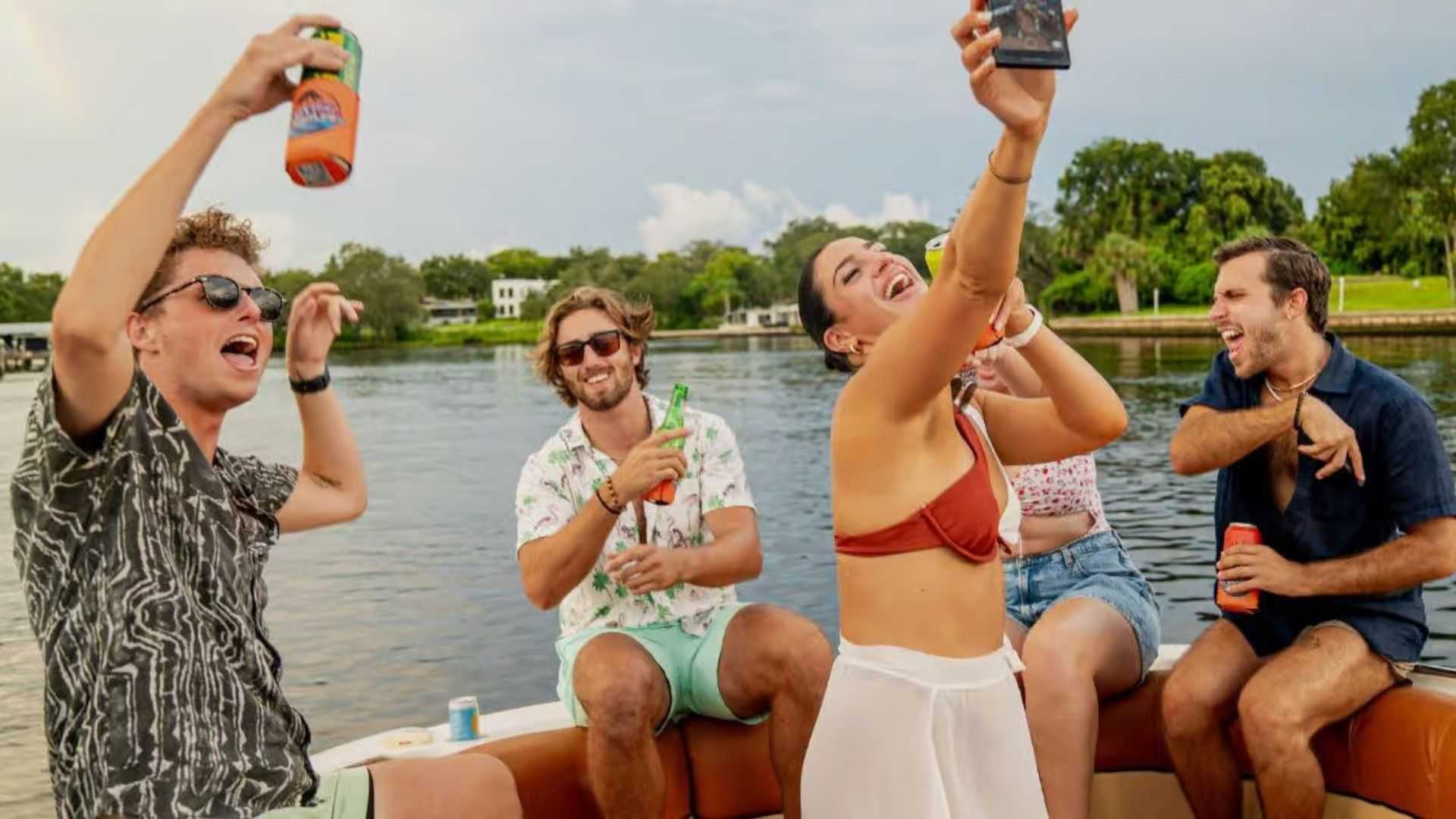 Large group dancing and enjoying music on a party boat.