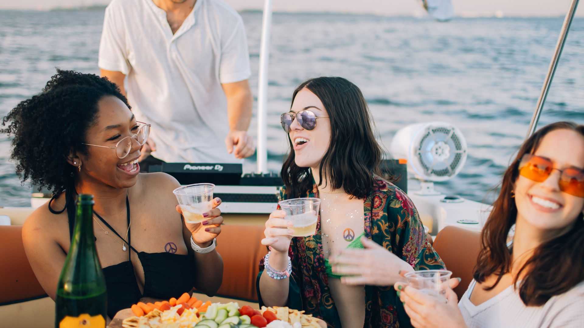 Friends celebrating a birthday on a private party boat in Tampa Bay, FL.