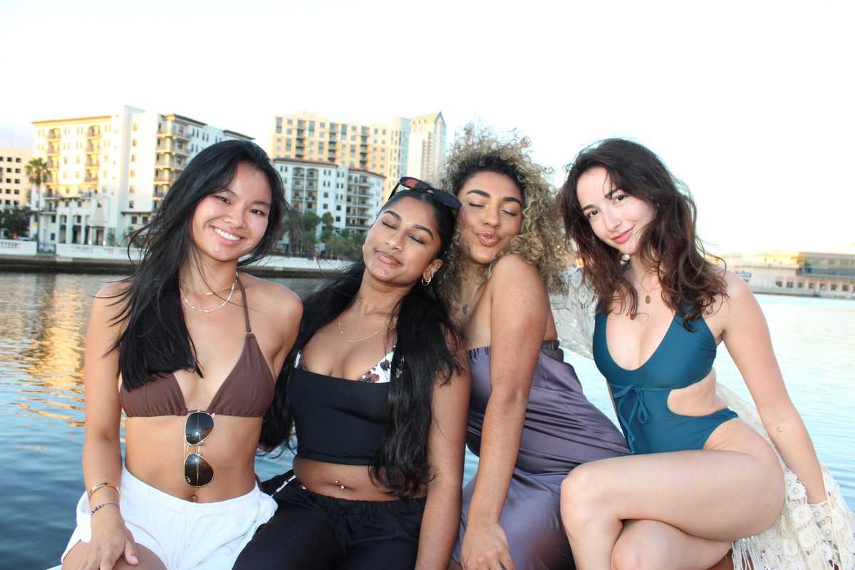 Four friends seated on the bow along the downtown Tampa waterfront.