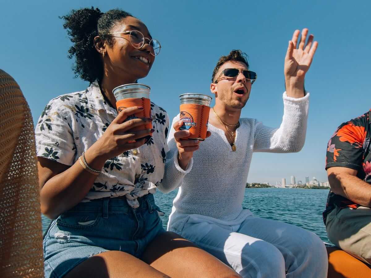 Guests relaxing with drinks on the way out to the island.