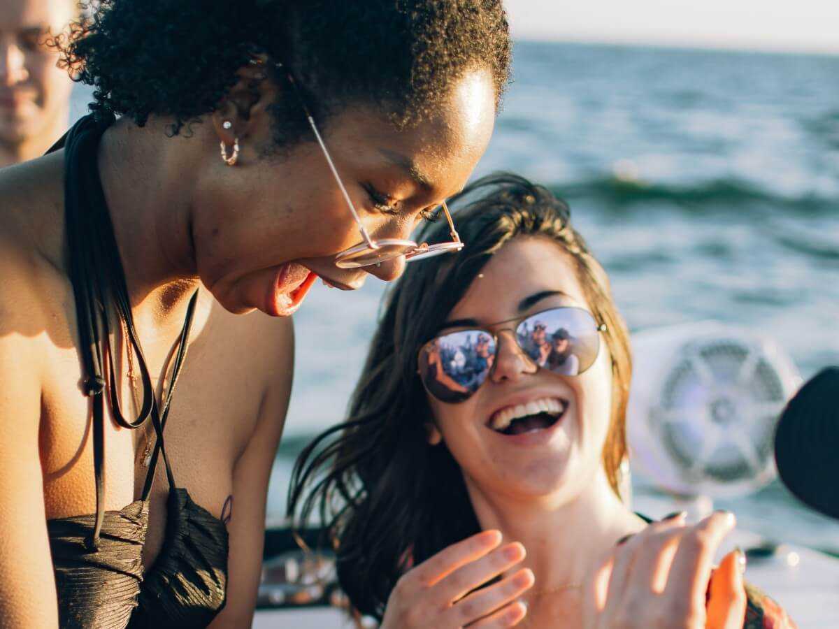 Two guests laughing together during a birthday charter.