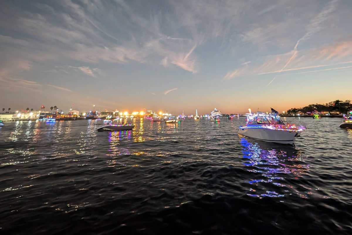 Parade boats lit up at blue hour on the Tampa waterfront.