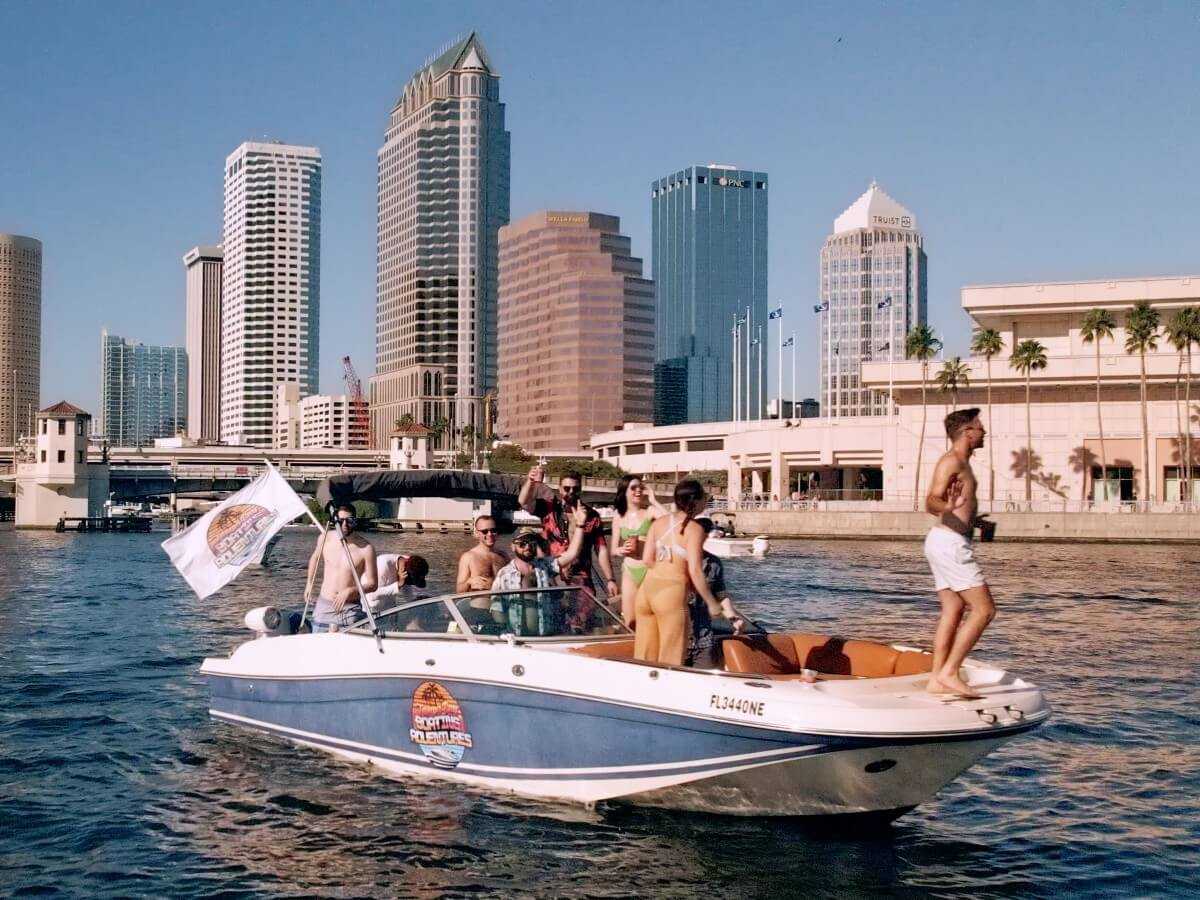 Party boat charter cruising past the city of Tampa.