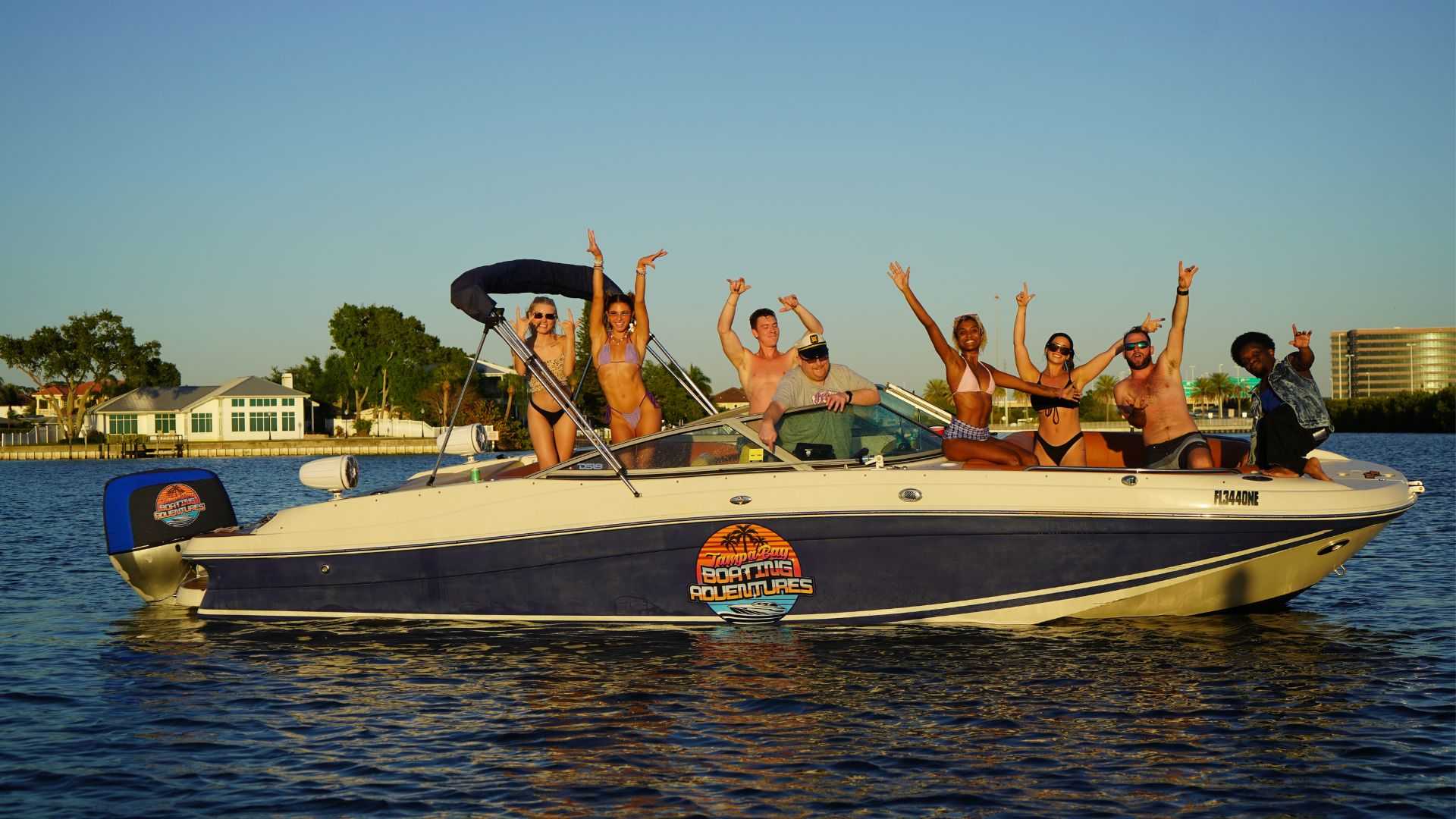 Friends enjoying a scenic boat route in Tampa Bay at golden hour.