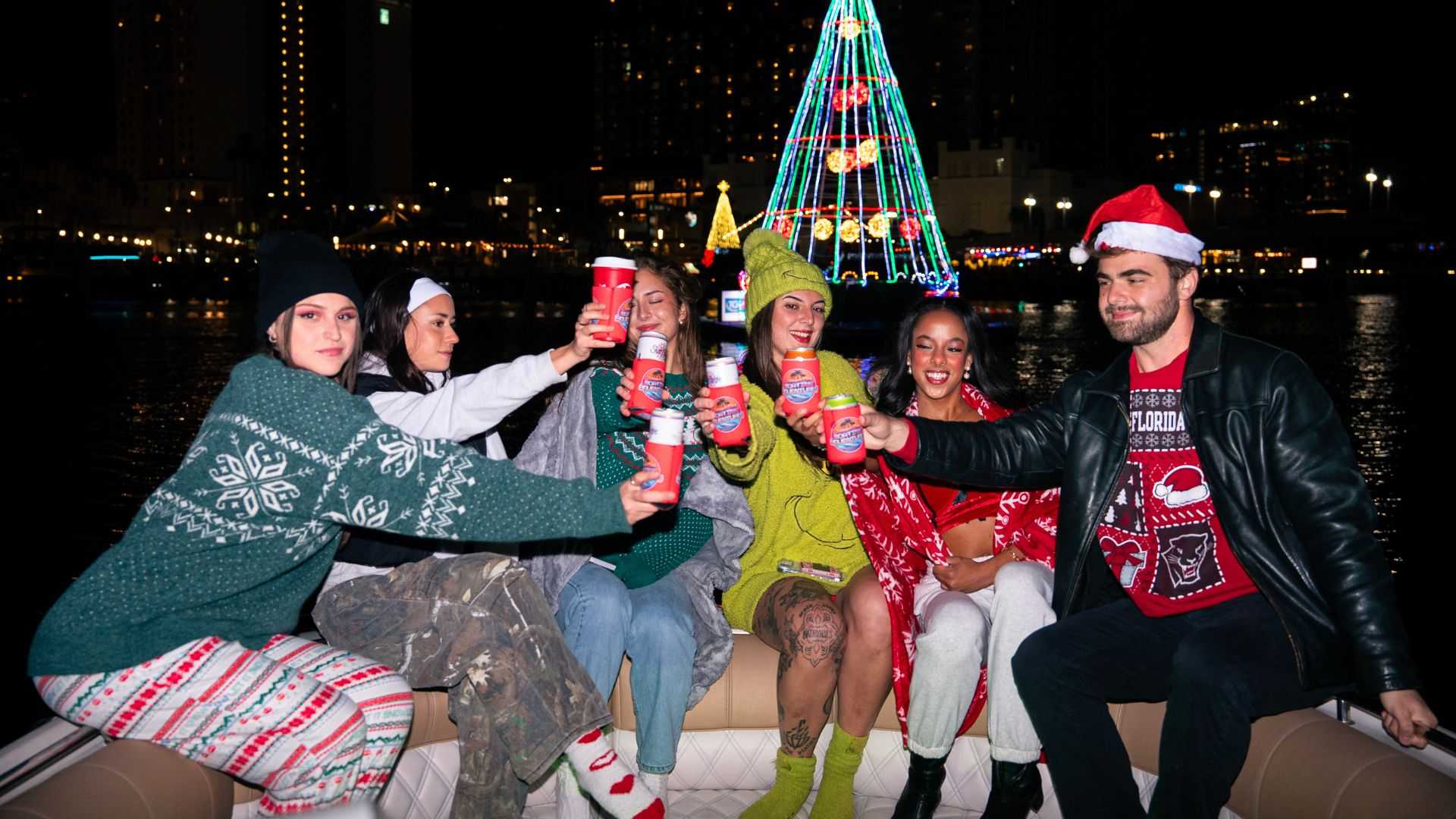 December holiday light show along the Tampa Riverwalk seen from a boat.