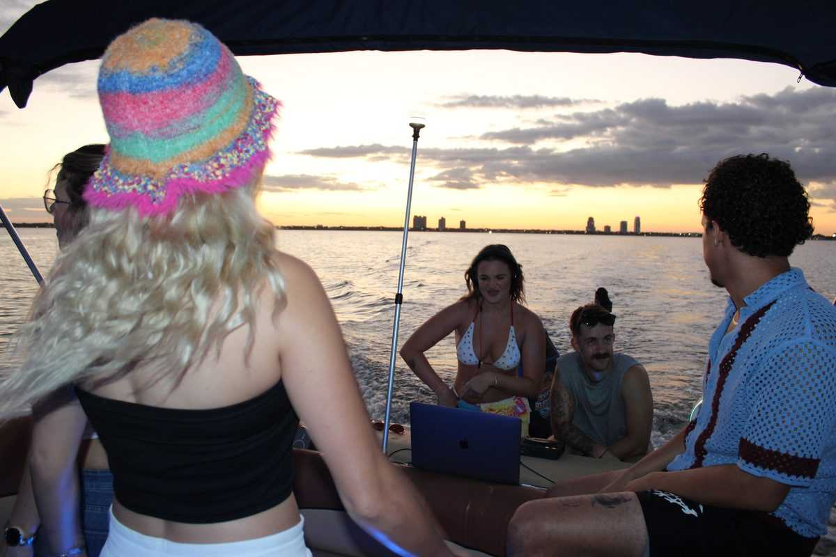 Guests silhouetted against the downtown Tampa skyline at sunset.