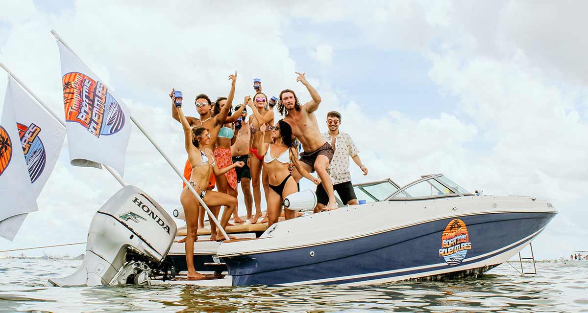 Friends on a party boat with flags raised near Tampa Bay, FL.