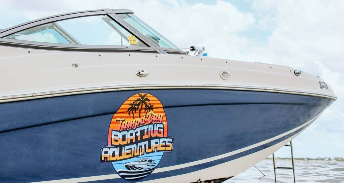 Tampa Bay Boating Adventures boat with logo near Tampa, FL.