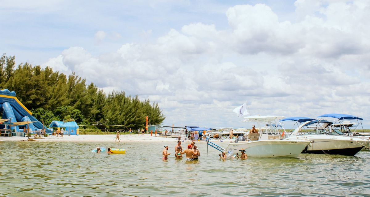 Friends on a party boat with flags raised near Tampa Bay, FL.
